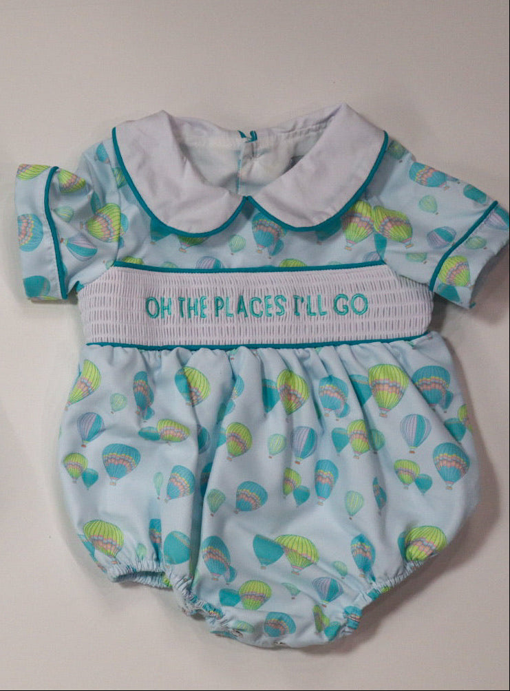 baby romper with smocked details on a light background